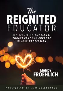 The Reignited Educator by Mandy Froehlich featuring a hand holding a sparkling heart-shaped sparkler against a dark, blurred background.