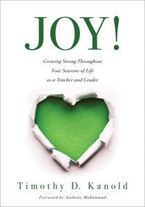 JOY!: Growing Strong Throughout Your Seasons of Life as a Teacher and Leader by Timothy D. Kanold Foreword by Anthony Muhammad, a torn paper effect revealing a green heart shape.