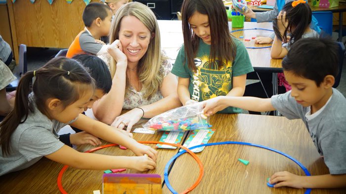 elementary school math students with teacher