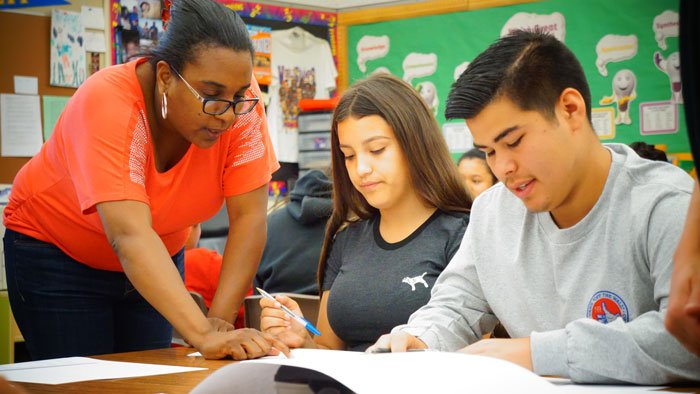 math teacher working with high school students